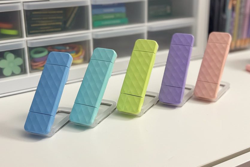 Ever After Creations portable rechargeable LED task lights in pastel blue, teal, lime, purple, and peach on a desk.