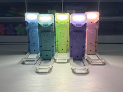 Ever After Creations portable rechargeable LED task lights in pastel blue, green, purple, and pink with folding stands.